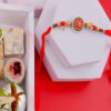 Red Enhanchting Rakhi with Sweets Hamper Online